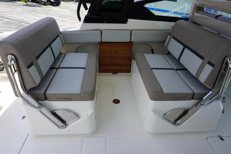 Slide: The Image of 2025 Boston Whaler 330 Vantage boat interior with gray seating and sleek design. - 37