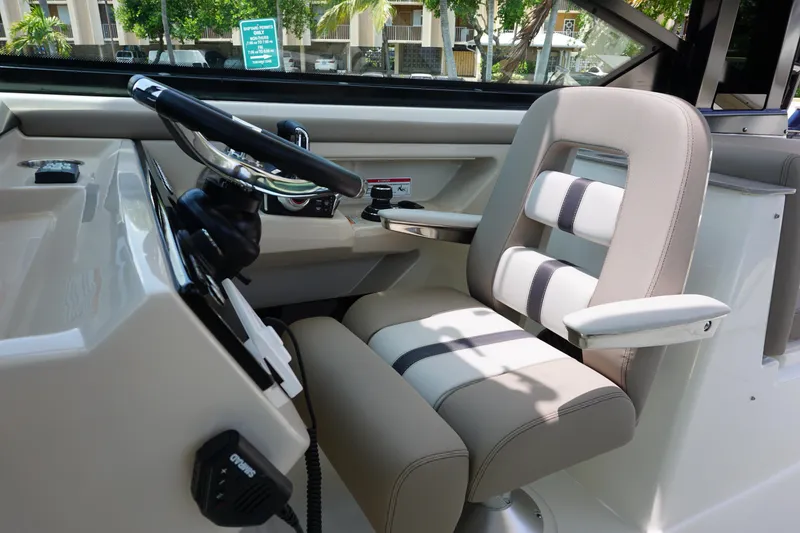 Slide: The Image of 2025 Boston Whaler 330 Vantage helm with modern steering and comfortable seating. - 44