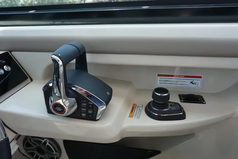 Slide: The Image of Control panel of 2025 Boston Whaler 330 Vantage boat, featuring throttle and joystick. - 49