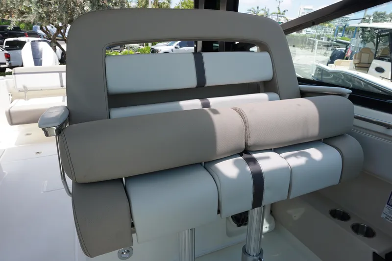 Slide: The Image of 2025 Boston Whaler 330 Vantage boat seat, featuring beige and white upholstery. - 50