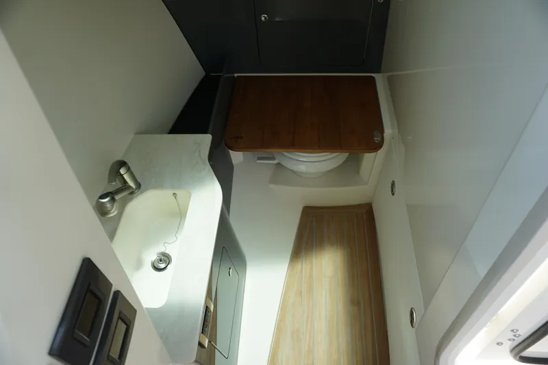 Slide: The Image of 2025 Boston Whaler 330 Vantage boat interior with sink and toilet. - 55