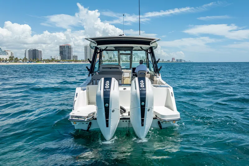 Slide: The Image of 2025 Boston Whaler 330 Vantage boat with twin 400 V10 engines on open water. - 6