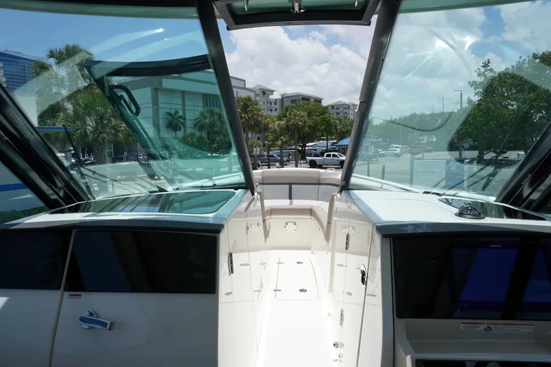 Slide: The Image of 2025 Boston Whaler 330 Vantage boat interior with glass windshield and modern dashboard. - 62