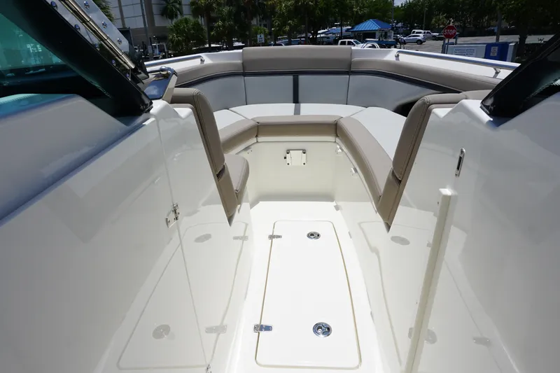 Slide: The Image of 2025 Boston Whaler 330 Vantage boat interior with cushioned seating and sleek design. - 63