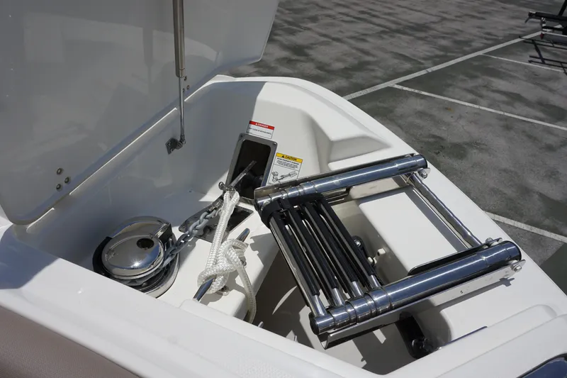 Slide: The Image of 2025 Boston Whaler 330 Vantage anchor compartment with ladder and rope. - 66