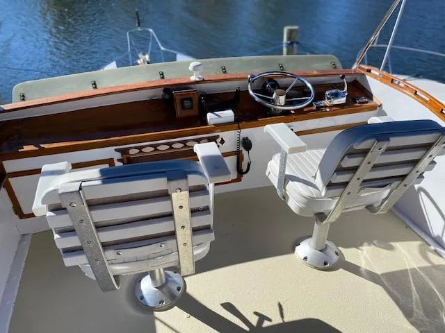 Slide: The Image of 1986 Wilbur 34 boat helm with dual captain chairs and steering wheel. - 10