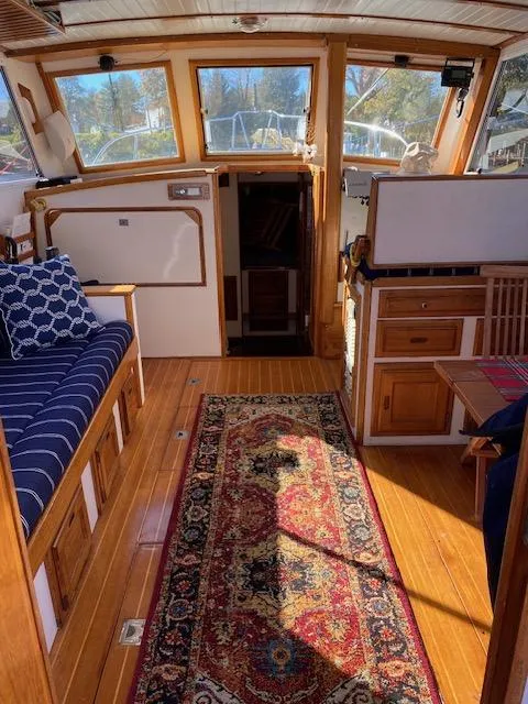 Slide: The Image of Interior of 1986 Wilbur 34 boat with wooden flooring and nautical decor. - 14