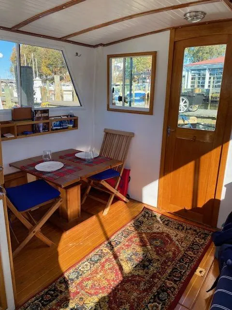 Slide: The Image of Cozy interior of 1986 Wilbur 34 boat with dining area and wooden decor. - 17
