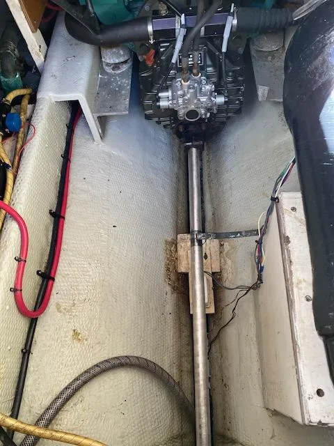 Slide: The Image of Engine compartment of a 1986 Wilbur 34 boat, showing mechanical components and wiring. - 28