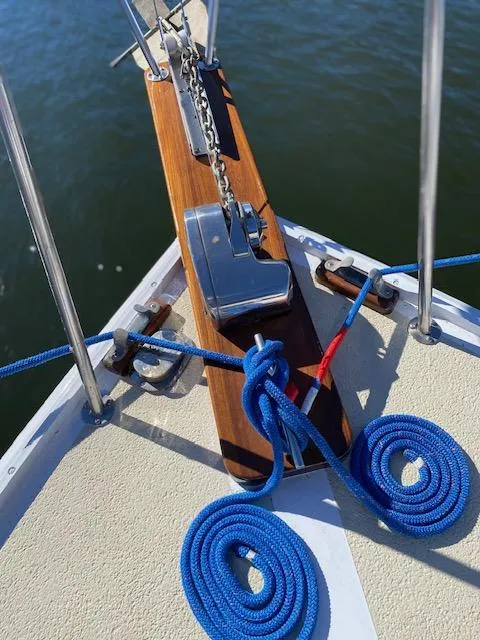 Slide: The Image of Bow of 1986 Wilbur 34 boat with anchor chain and blue ropes. - 9