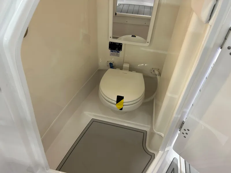 Slide: The Image of 2025 Sea Fox 268 Traveler boat bathroom interior with toilet and mirror. - 11