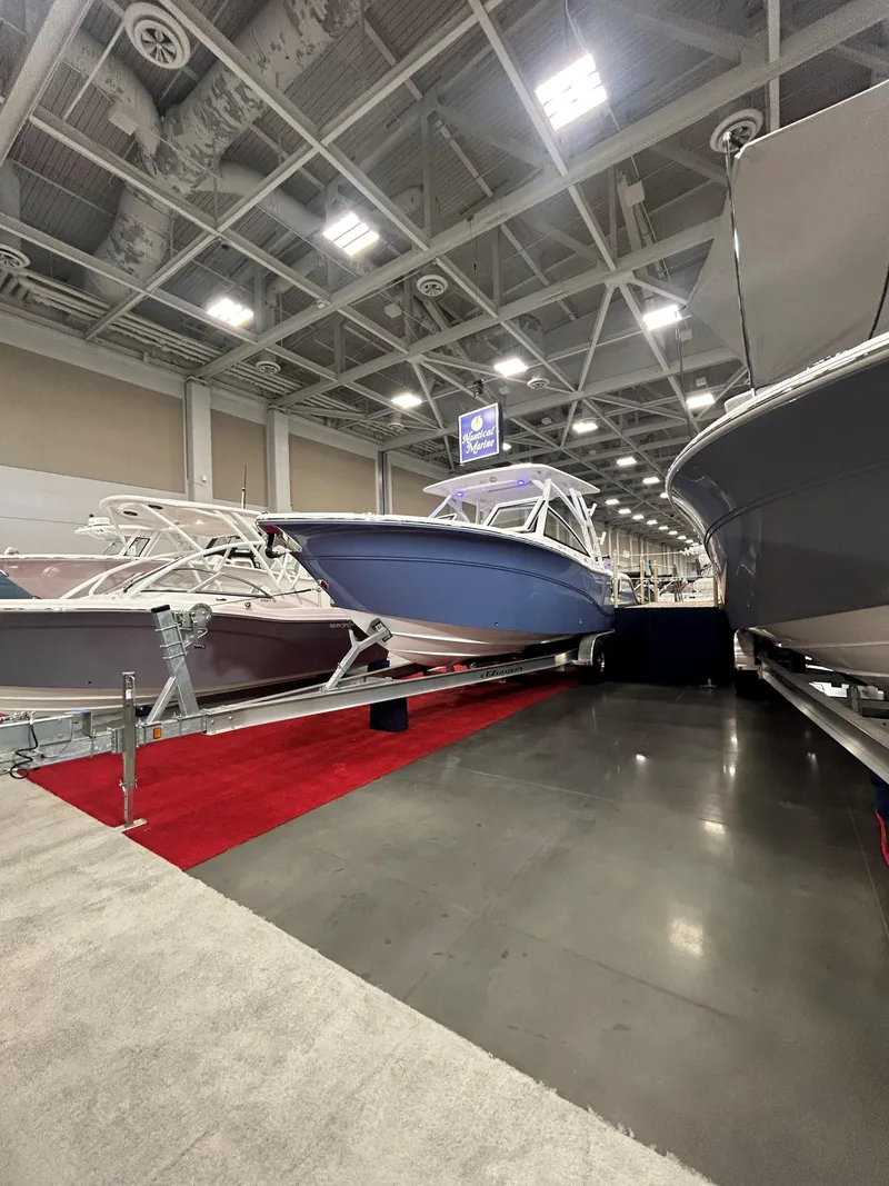 Slide: The Image of 2025 Sea Fox 268 Traveler boat displayed at an indoor exhibition. - 14