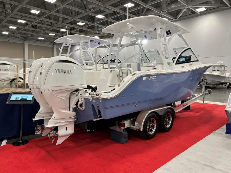 Slide: The Image of 2025 Sea Fox 268 Traveler boat on display with Yamaha engines, showcased indoors on a red carpet. - 15