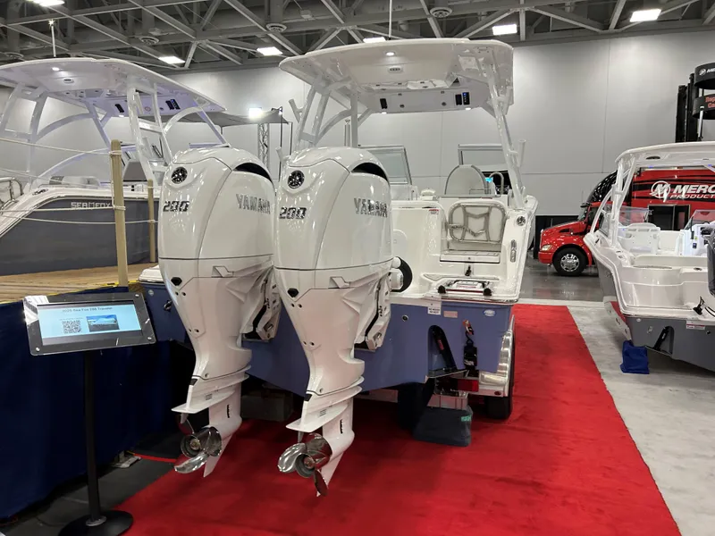 Slide: The Image of 2025 Sea Fox 268 Traveler boat with dual engines on display at a boat show. - 16