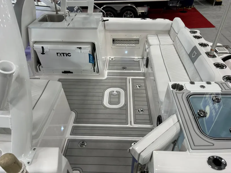 Slide: The Image of 2025 Sea Fox 268 Traveler boat interior with seating, cooler, and fishing rod holders. - 19