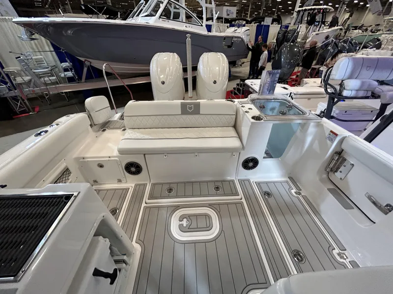 Slide: The Image of 2025 Sea Fox 268 Traveler boat interior with seating and deck features at a boat show. - 27