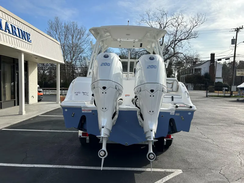 Slide: The Image of 2025 Sea Fox 268 Traveler boat with dual 200 horsepower engines in a parking lot. - 6