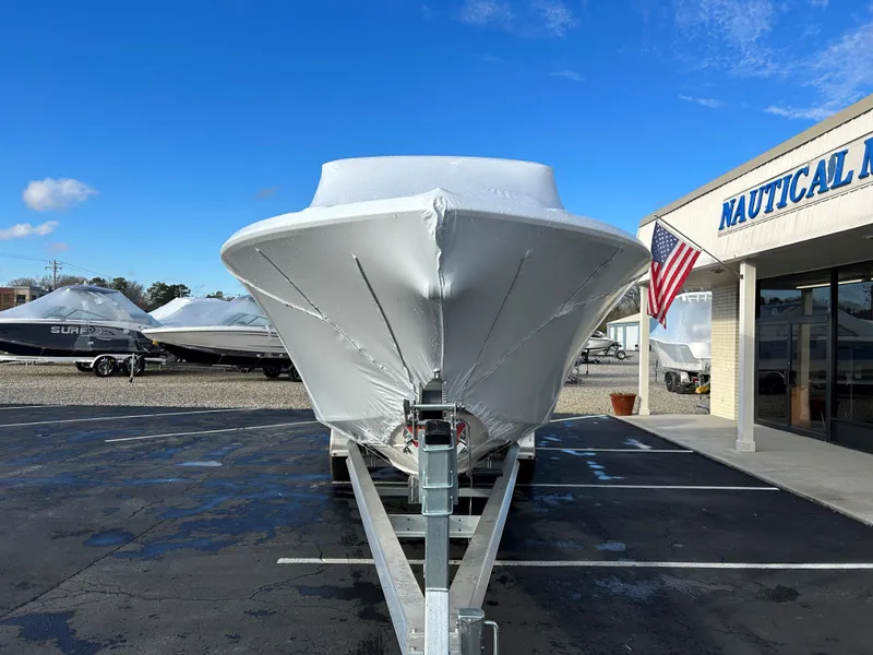 Slide: The Image of 2025 Sea Fox 288 Traveler boat covered in white tarp at a dealership. - 10