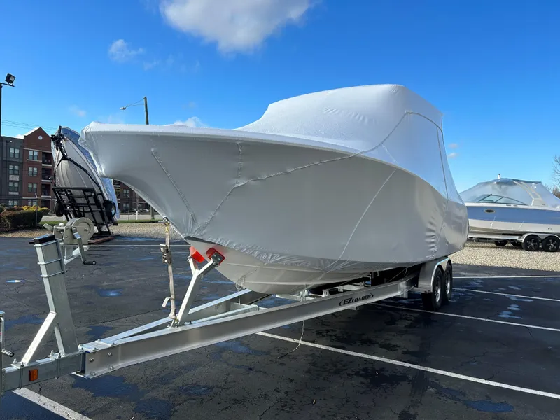 Slide: The Image of 2025 Sea Fox 288 Traveler boat covered on a trailer in a parking lot. - 11