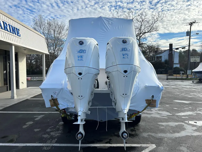 Slide: The Image of 2025 Sea Fox 288 Traveler with twin outboard engines, covered and parked outdoors. - 13