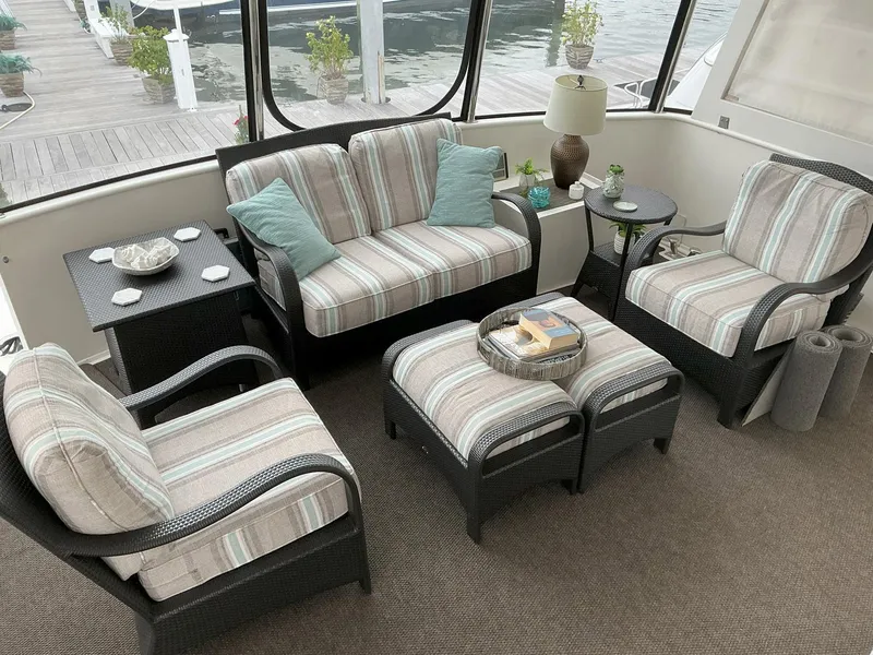 Slide: The Image of Cozy seating area on 2000 Novatec Islander 55 yacht with striped cushions and waterfront view. - 10
