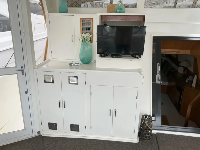 Slide: The Image of Interior of 2000 Novatec Islander 55 yacht with cabinets and mounted TV. - 13