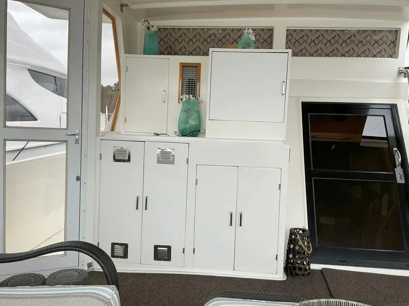 Slide: The Image of Interior of 2000 Novatec Islander 55 yacht with white cabinets and decor. - 16