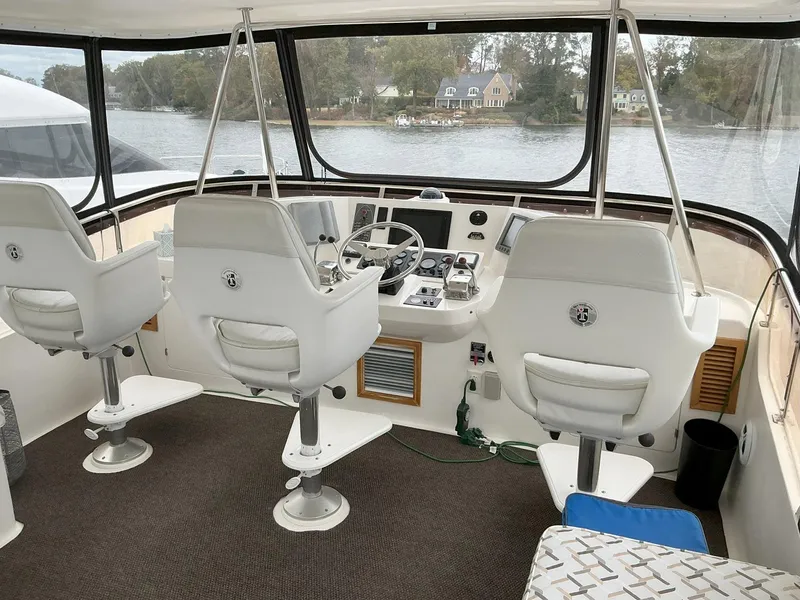Slide: The Image of Cockpit of 2000 Novatec Islander 55 yacht with three white captain chairs. - 17