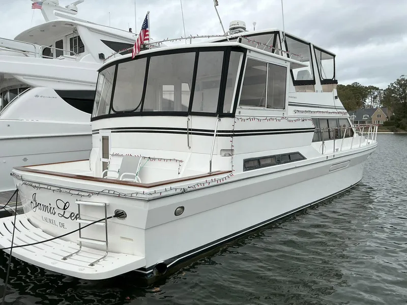 Slide: The Image of Novatec Islander 55 yacht, 2000 model, docked in a marina with American flag. - 2