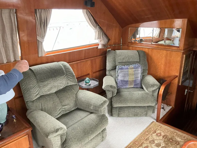 Slide: The Image of Interior of 2000 Novatec Islander 55 yacht with plush armchairs and wooden paneling. - 28