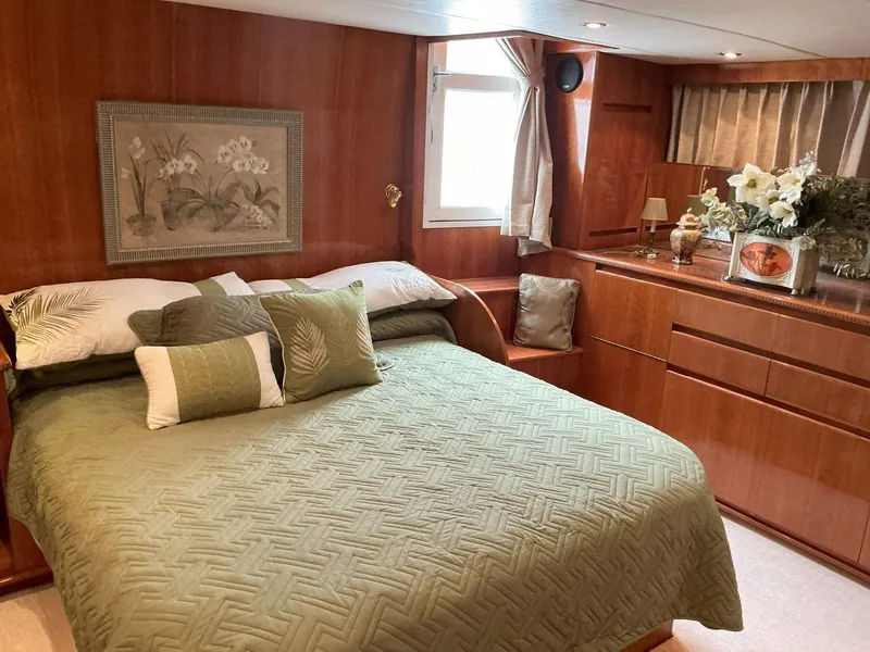 Slide: The Image of Luxurious bedroom in 2000 Novatec Islander 55 yacht with green bedding and wooden decor. - 32