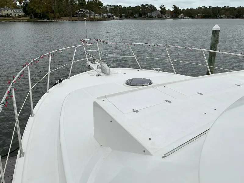 Slide: The Image of Novatec Islander 55 yacht deck, 2000 model, docked by a serene waterfront. - 4