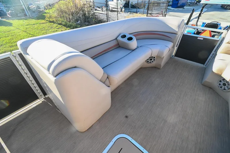 Slide: The Image of 2017 Bennington 23 GCW pontoon boat interior with beige seating and cup holders. - 11