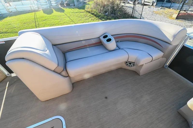 Slide: The Image of 2017 Bennington 23 GCW boat interior with beige seating and cup holders. - 12