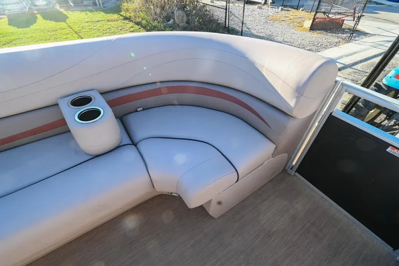 Slide: The Image of 2017 Bennington 23 GCW pontoon boat interior with beige seating and cup holders. - 13