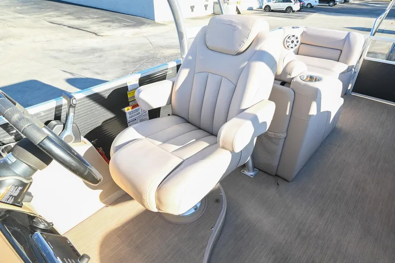 Slide: The Image of 2017 Bennington 23 GCW boat interior with beige captain's chair and steering wheel. - 22