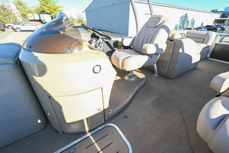 Slide: The Image of 2017 Bennington 23 GCW boat interior with beige captain's chair and console. - 25