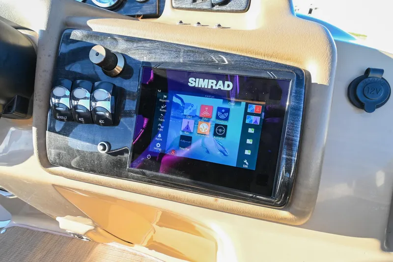 Slide: The Image of Simrad display on 2017 Bennington 23 GCW boat dashboard with control switches. - 28