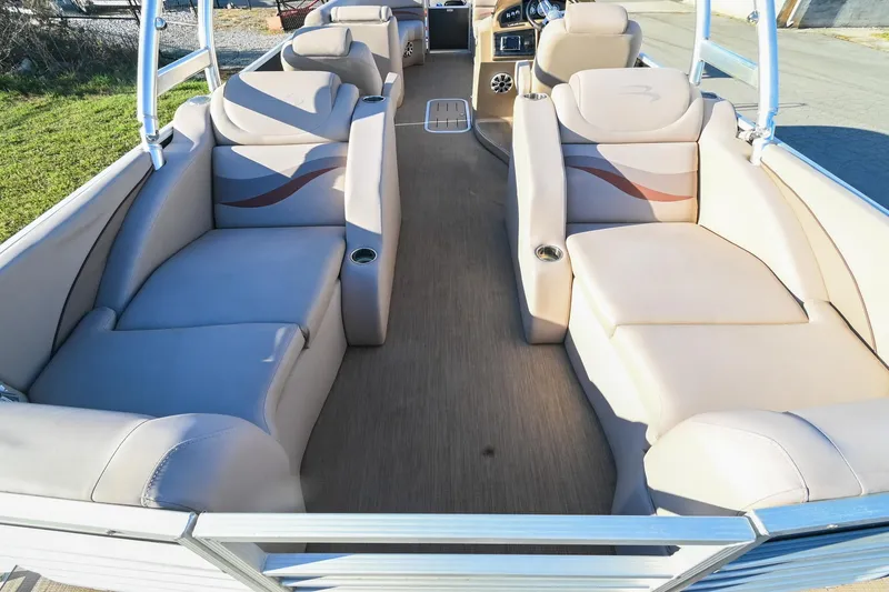 Slide: The Image of 2017 Bennington 23 GCW pontoon boat interior with beige seating and spacious layout. - 33