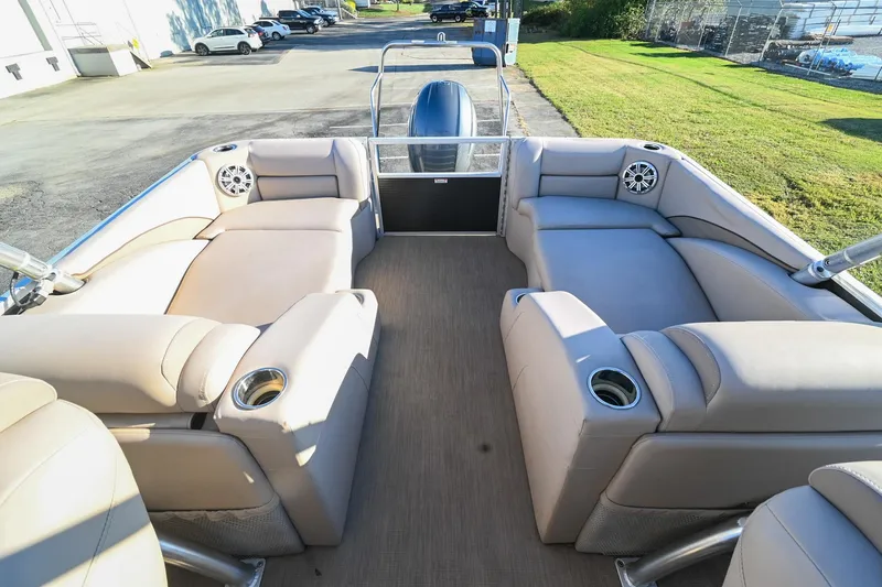 Slide: The Image of 2017 Bennington 23 GCW pontoon boat interior with beige seating and cup holders. - 35