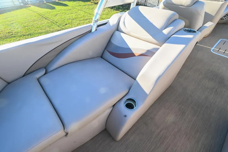 Slide: The Image of 2017 Bennington 23 GCW boat interior with beige seating and cup holders. - 36