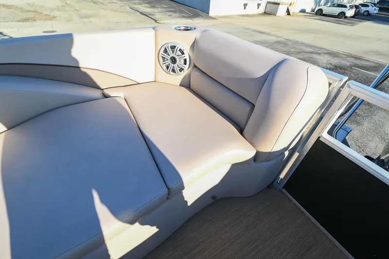 Slide: The Image of 2017 Bennington 23 GCW boat interior with beige seating and speaker. - 38