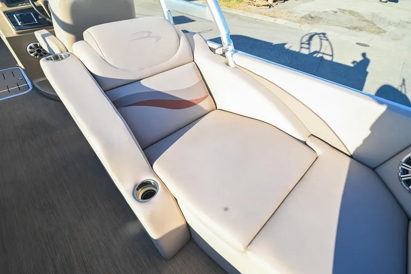 Slide: The Image of 2017 Bennington 23 GCW boat interior with beige seating and cup holders. - 39