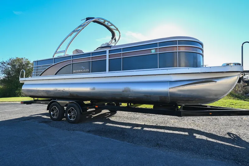 Slide: The Image of 2017 Bennington 23 GCW pontoon boat on a trailer under clear blue sky. - 4