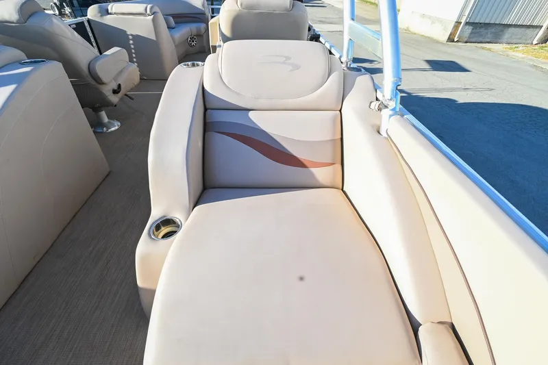 Slide: The Image of 2017 Bennington 23 GCW boat interior with beige seating and cup holder. - 40
