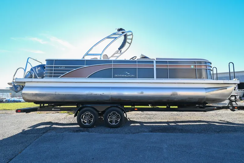 Slide: The Image of 2017 Bennington 23 GCW pontoon boat on trailer under clear blue sky. - 5