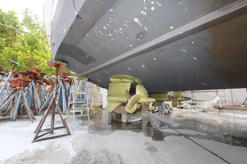 Slide: The Image of 2014 Sunseeker San Remo yacht under maintenance, showing propellers and supports. - 11