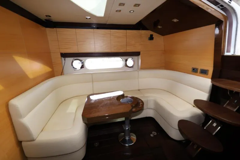 Slide: The Image of Luxurious interior of 2014 Sunseeker San Remo yacht with elegant seating and wooden table. - 14
