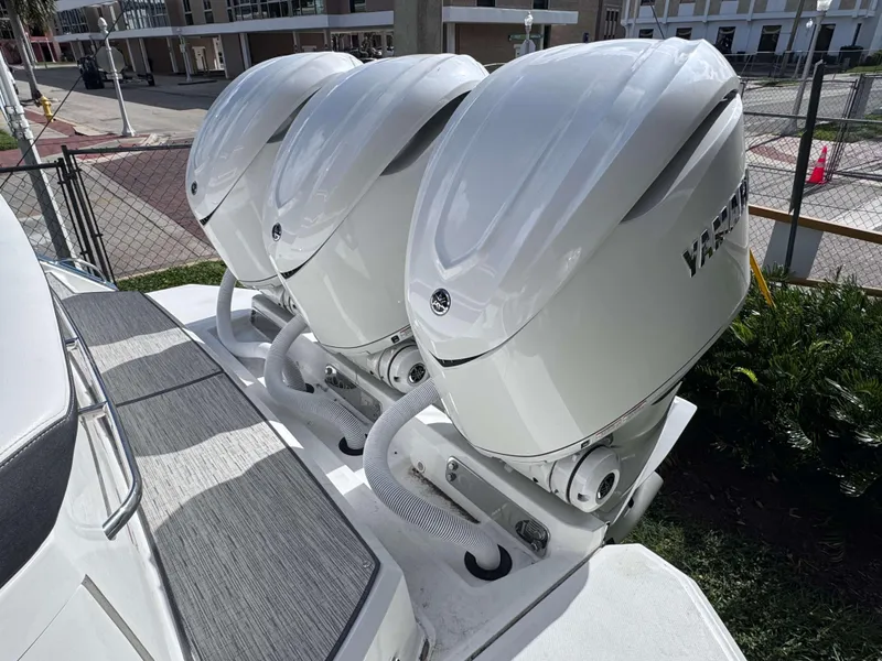 Slide: The Image of Triple outboard motors on a 2025 Cobalt R35 boat, docked outdoors. - 3