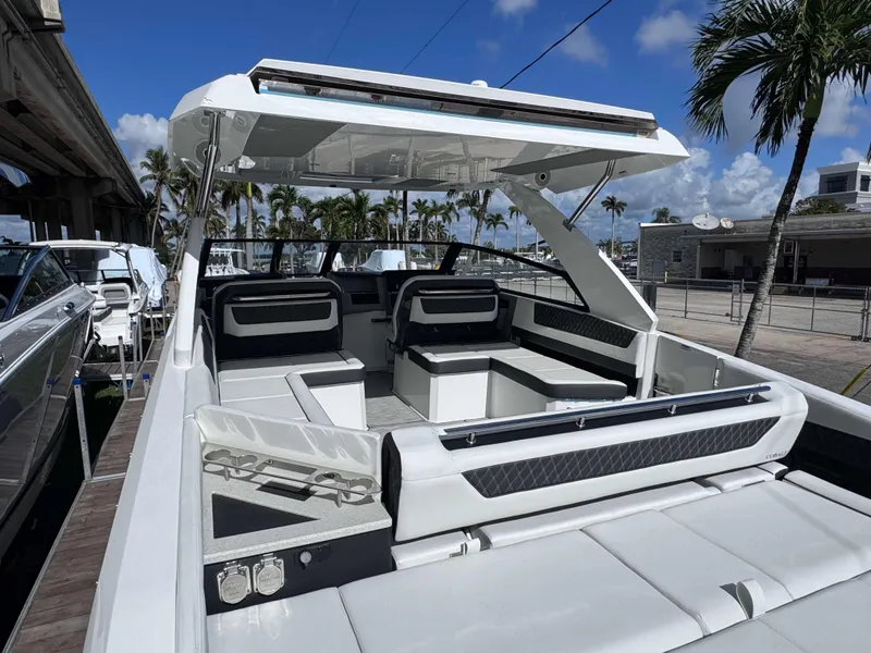 Slide: The Image of 2025 Cobalt R35 luxury boat interior with seating, docked under clear skies. - 4